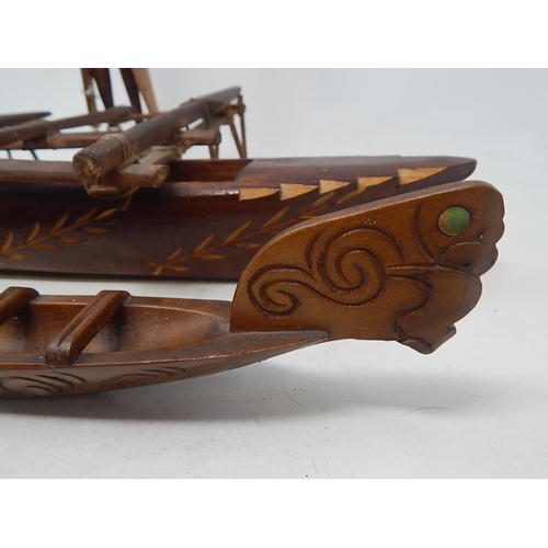 561 - Tribal Carved Wooden Figure 31cm: together with Two carved Wooden Boats 44cm & 37cm