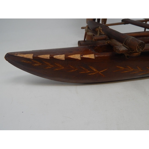 561 - Tribal Carved Wooden Figure 31cm: together with Two carved Wooden Boats 44cm & 37cm