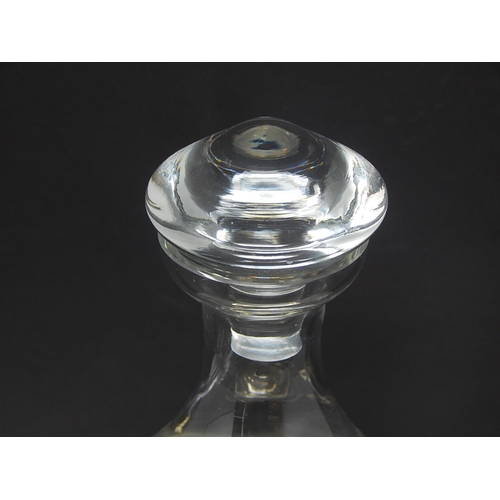 587 - BODA: Shaped Clear Glass Decanter & Stopper on White Metal Stand. Height 26.5cm