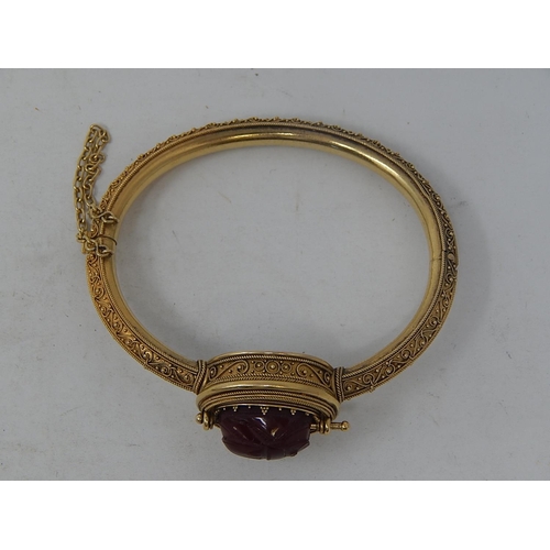 37 - 18ct Yellow Gold Victorian bangle featuring swivel maroon Intaglio seal with scarab beetle decoratio... 