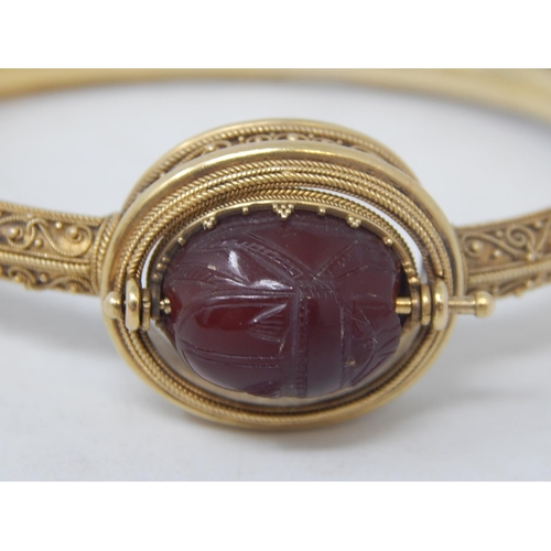 37 - 18ct Yellow Gold Victorian bangle featuring swivel maroon Intaglio seal with scarab beetle decoratio... 