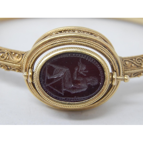 37 - 18ct Yellow Gold Victorian bangle featuring swivel maroon Intaglio seal with scarab beetle decoratio... 