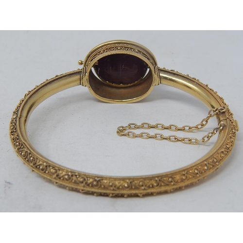 37 - 18ct Yellow Gold Victorian bangle featuring swivel maroon Intaglio seal with scarab beetle decoratio... 