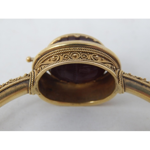 37 - 18ct Yellow Gold Victorian bangle featuring swivel maroon Intaglio seal with scarab beetle decoratio... 