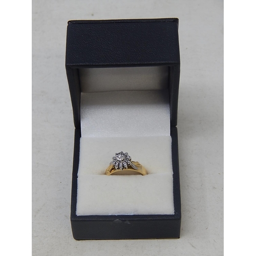 38 - 18ct Yellow & White gold diamond ring with 11 round cut brilliant cut diamonds claw set in cluster