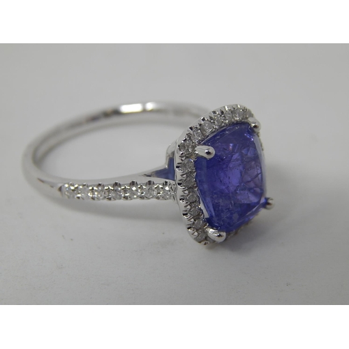 52 - 18ct White Gold Tanzanite & Diamond ring featuring centre cushion cut dark violet blue Tanzanite (4.... 