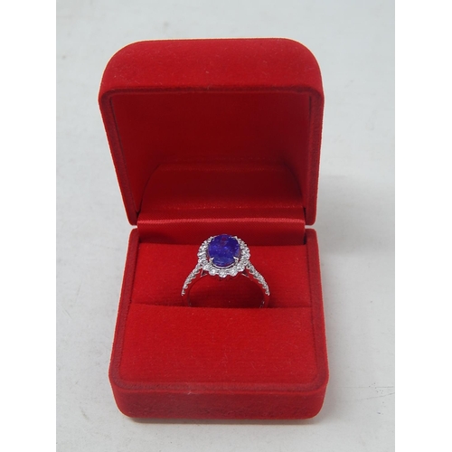 53 - 18ct White Gold tanzanite & diamond ring with centre oval cut pupleish blue Tanzanite (2.56ct)claw s... 