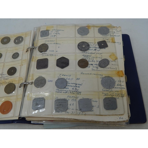 134 - Vintage coin album containing a substantial collection of World coins and tokens