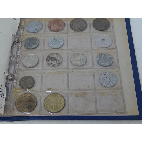 168 - Very substantial collection of USA amusement machine tokens housed in vintage album