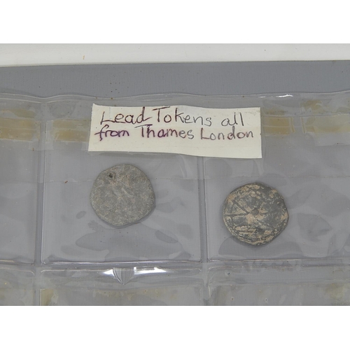 222 - An album with a large collection of leaden tokens, some found in the Thames, with a large quantity o... 