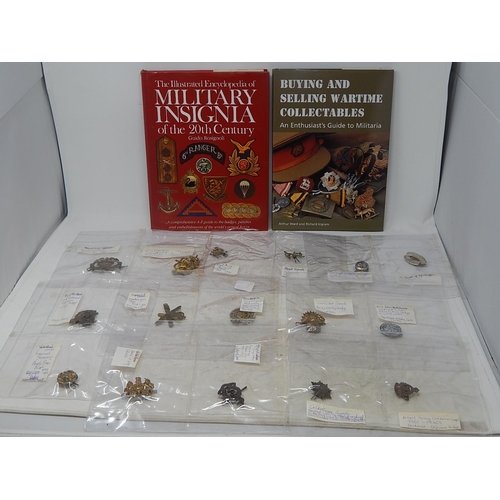 403 - Military cap badges, etc and a collectors book