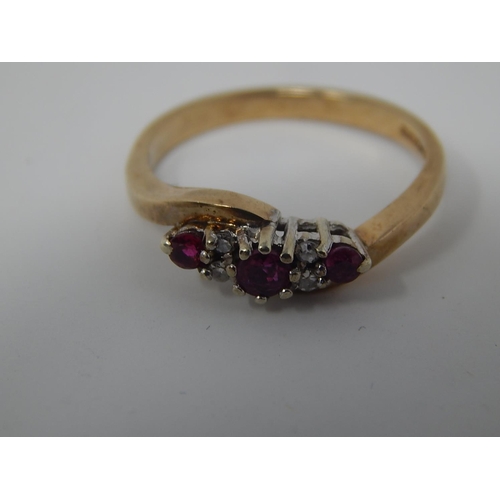 135 - 9ct Gold Ring Set with Three Rubies & Four Diamonds: Size K 1/2.