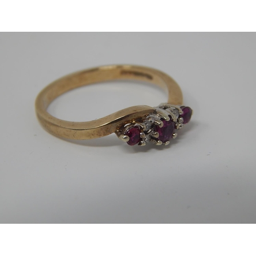 135 - 9ct Gold Ring Set with Three Rubies & Four Diamonds: Size K 1/2.