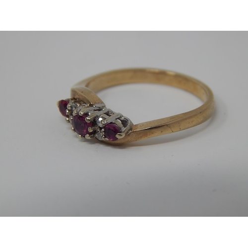 135 - 9ct Gold Ring Set with Three Rubies & Four Diamonds: Size K 1/2.