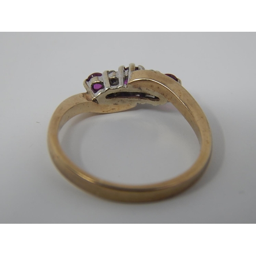 135 - 9ct Gold Ring Set with Three Rubies & Four Diamonds: Size K 1/2.