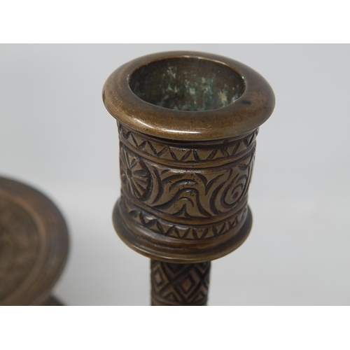 142 - Pair of Islamic/Middle Eastern Bronze Candlesticks with engraved decoration. Each Measuring 20.5cm h... 