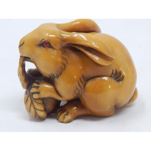 157 - Japanese Signed Netsuke of a Hare with Red Amber Eyes eating the leaf of a vegetable: Edo/Meiji Peri... 