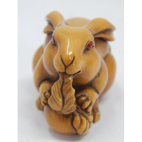 157 - Japanese Signed Netsuke of a Hare with Red Amber Eyes eating the leaf of a vegetable: Edo/Meiji Peri... 