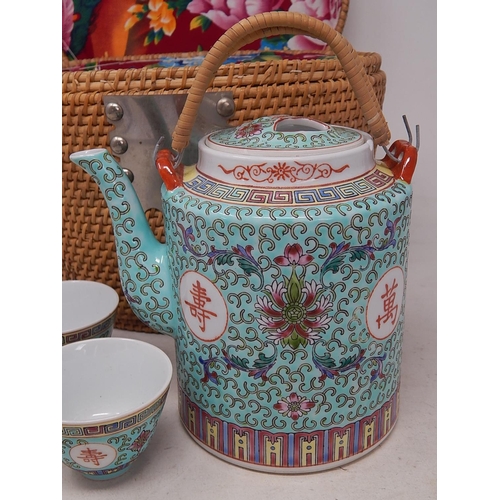 173 - Chinese Tea Pot & Tea Bowls contained within their fitted silk lined wicker basket. Tea Pot 15cm hig... 