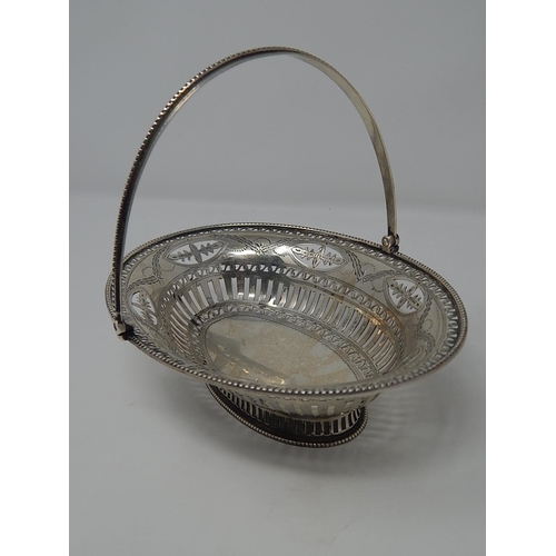 1 - Antique Silver Swing Handled Basket with gadrooned rim & beaded handle sitting on a pierced oval bas... 