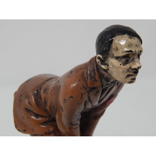 512 - WWII: A novelty Adolf Hitler cold painted bronze figural pin cushion, realistically modelled bent-ov... 