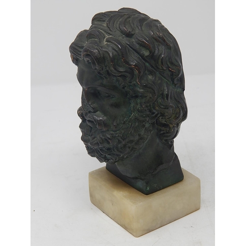 497 - Antique Bronze Head of a God on Alabaster Base: Measures 16.5cm High.