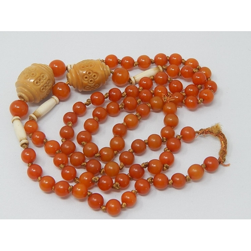 136 - 1920's Amber Necklace with Ivory & Stained Ivory Spacers: Length 90cm: Gross Weight 37g