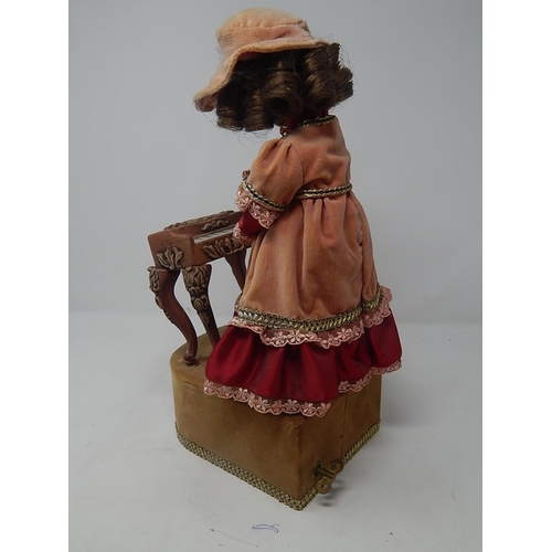 551 - Vintage Automaton Musical Doll Playing The Piano. Note: The Ceramic Piano needs one leg reattaching.... 