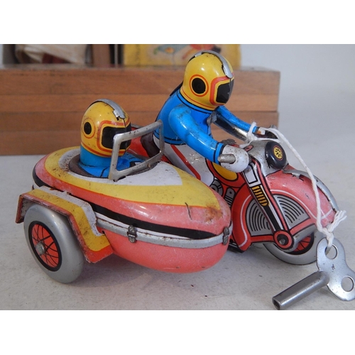 598 - Pelham Puppet in original box together with a tin plate clockwork motorcycle & sidecar with key: Woo... 