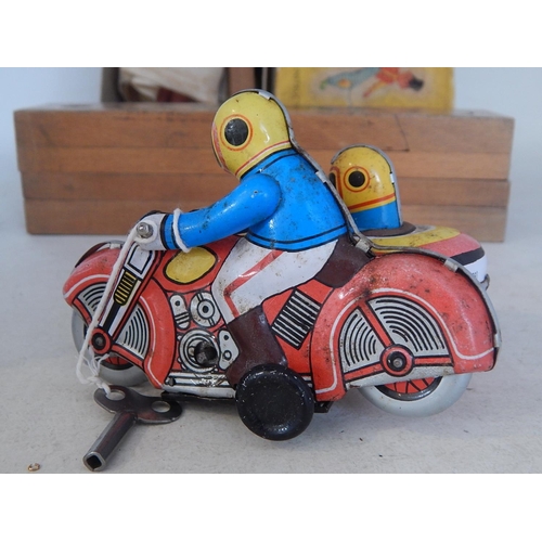 598 - Pelham Puppet in original box together with a tin plate clockwork motorcycle & sidecar with key: Woo... 