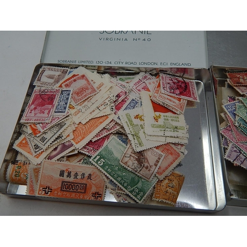 179 - Two tins containing China and South Africa stamps; selection of GB stamps on various album pages