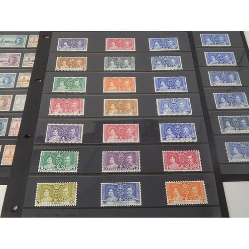 108 - A large selection of 1937 Coronation stamps and 1946 Victory Stamps all Mint housed on 5 Hagner shee... 