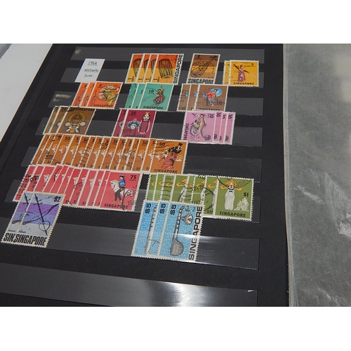 120 - A collection of Singapore stamps housed in vintage stock book, with a few Channel Island, Malaya sta... 