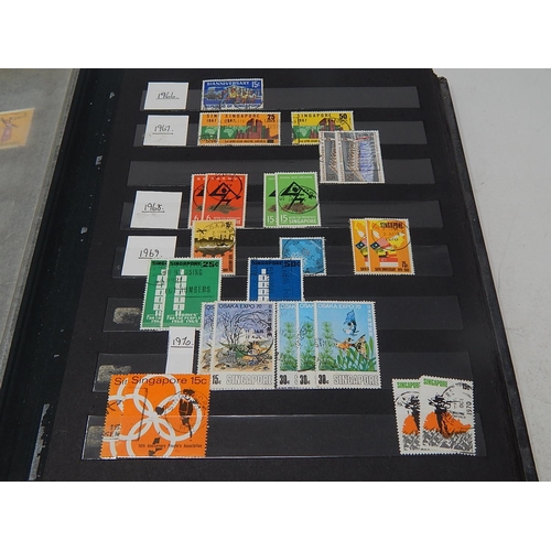 120 - A collection of Singapore stamps housed in vintage stock book, with a few Channel Island, Malaya sta... 