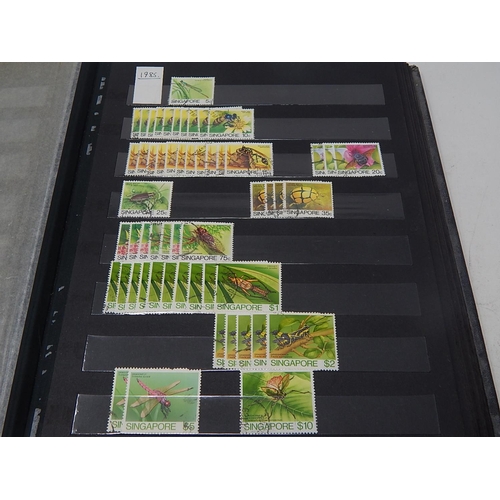 120 - A collection of Singapore stamps housed in vintage stock book, with a few Channel Island, Malaya sta... 