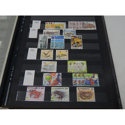 120 - A collection of Singapore stamps housed in vintage stock book, with a few Channel Island, Malaya sta... 