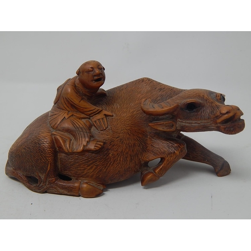 609 - Chinese Carved Wooden Ox with a Figure on Its Back: Measures 14cm wide: A/F