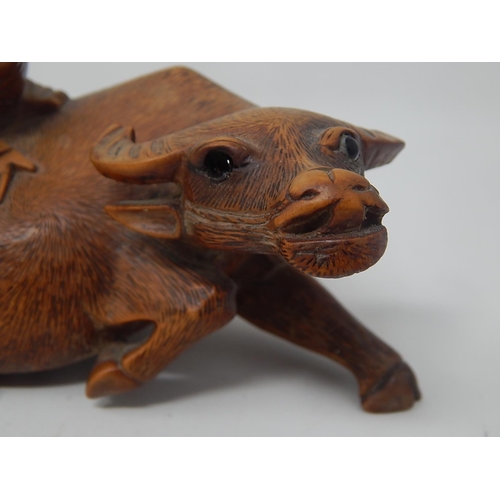 609 - Chinese Carved Wooden Ox with a Figure on Its Back: Measures 14cm wide: A/F