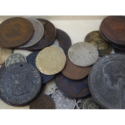 110 - A Fortnum and Mason box containing an interesting selection of coins and tokens