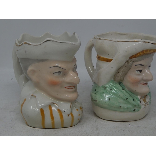 802 - Two Early C20th Toby Jugs of a man and woman.