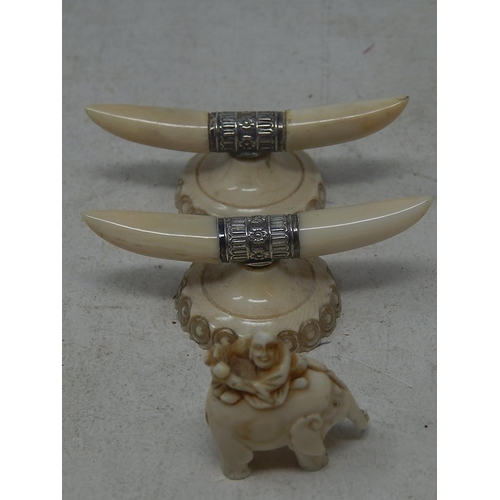 818 - Two C19th Ivory Knife Rests together with an Ivory Elephant with a Buddha.