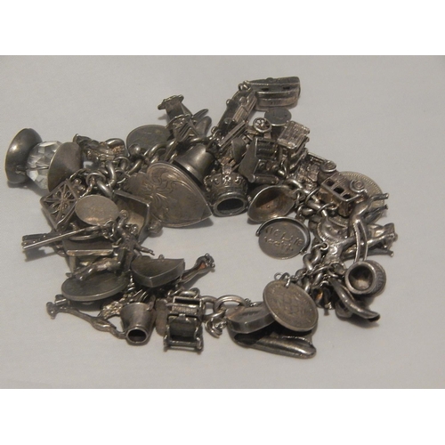 363E - Heavy Silver Charm Bracelet with Numerous Charms: Gross weight 147g