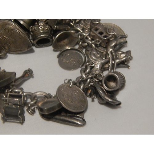 363E - Heavy Silver Charm Bracelet with Numerous Charms: Gross weight 147g