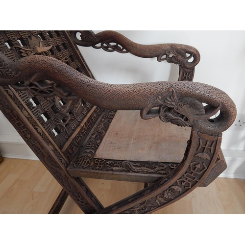 313 - 19th Century Chinese Folding Chair Profusely Carved with Dragons & Character Marks. The Folding Arms... 