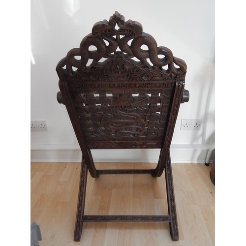 313 - 19th Century Chinese Folding Chair Profusely Carved with Dragons & Character Marks. The Folding Arms... 