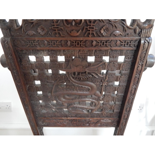 313 - 19th Century Chinese Folding Chair Profusely Carved with Dragons & Character Marks. The Folding Arms... 