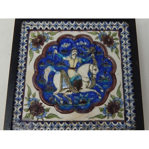 324 - Qajar moulded polychrome pottery tile.
Moulded and painted in underglaze blue, green & mauve depicti... 