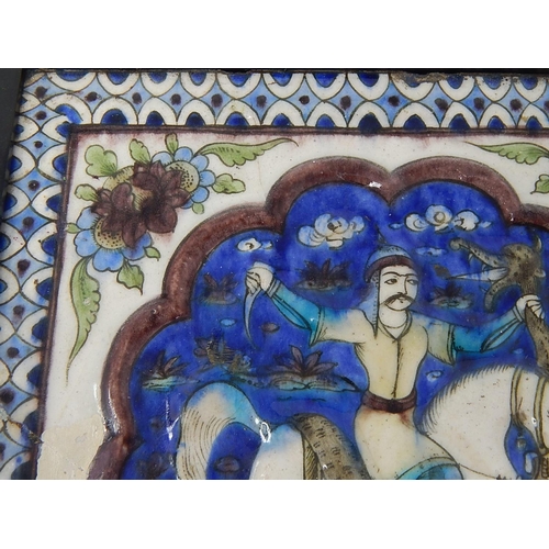 324 - Qajar moulded polychrome pottery tile.
Moulded and painted in underglaze blue, green & mauve depicti... 