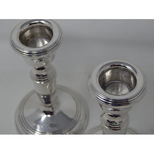 150 - Pair of silver candlesticks, 11.2 cm high, Birmingham 1976