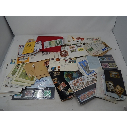 385 - Red stock book containing UK stamps, a further album, FDC's, envelopes etc together with a £1.00 ban... 